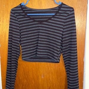 A trendy black and grey striped long sleeved crop top